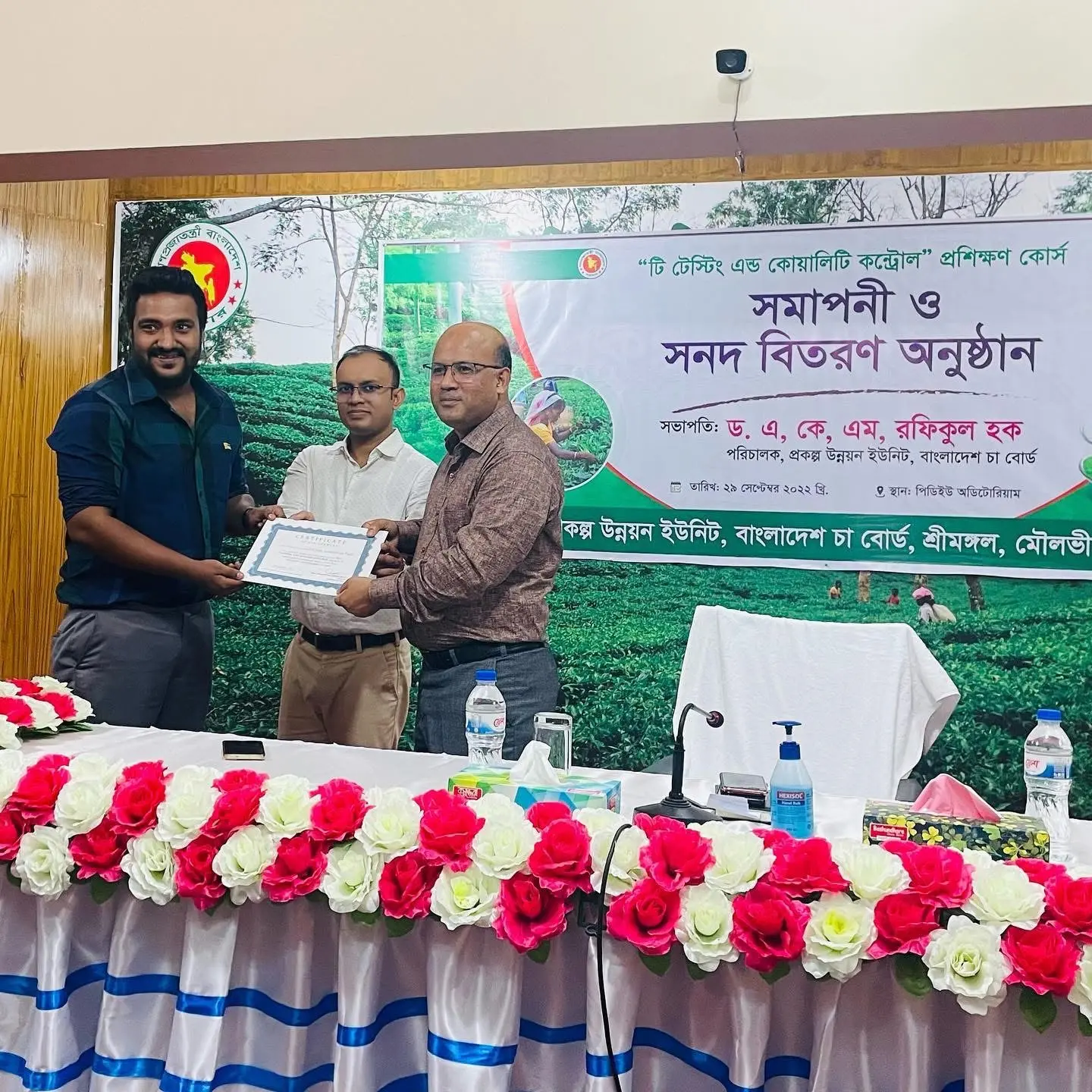 Cyrus receiving a framed certificate at a formal event