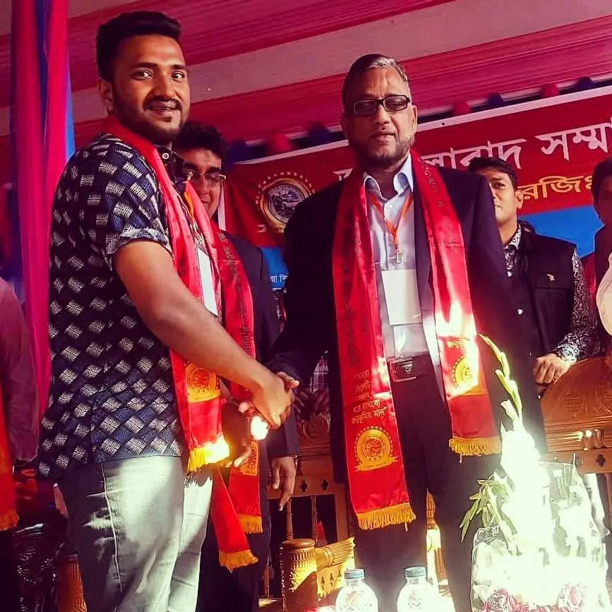 Cyrus receiving a ceremonial scarf at a community programme